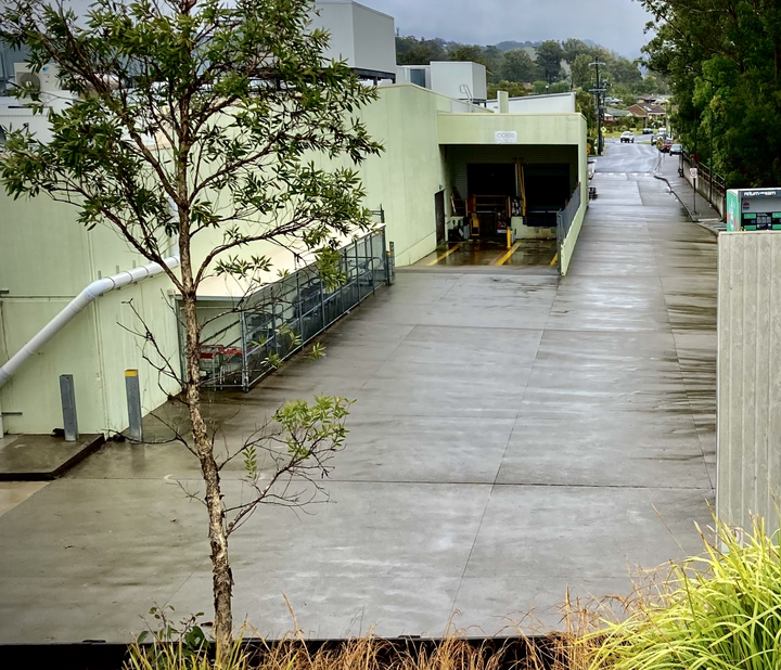 an Australian regional supermarket loading dock in a rain drenched car park