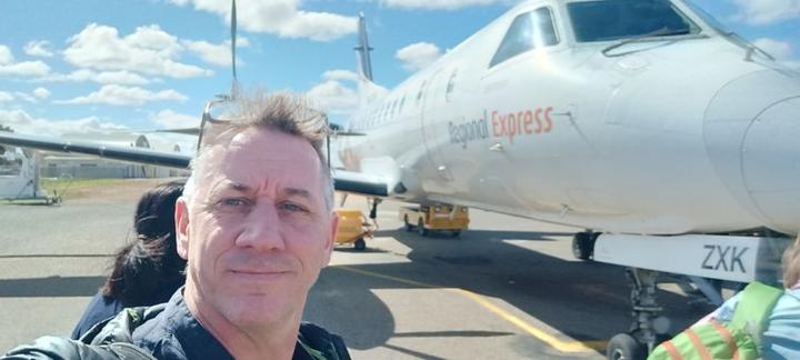A selfie in front of a Saab 340 turboprob aeroplane on the apron at Broken Hill [BHX] airport