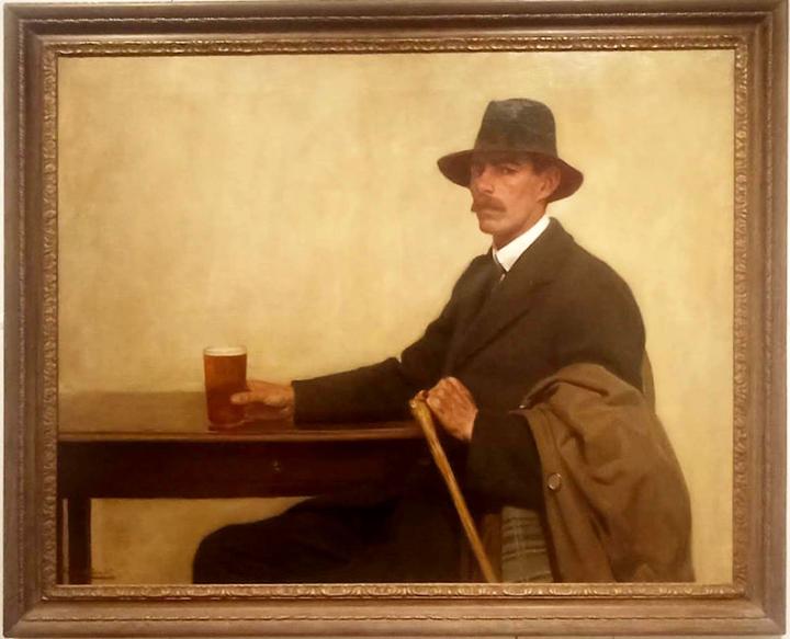 A Harold Knight (Newlyn School) painting of Robert Morson Hughes, sat at a table with a pint of beer in his hand, has coat and cane over his arm